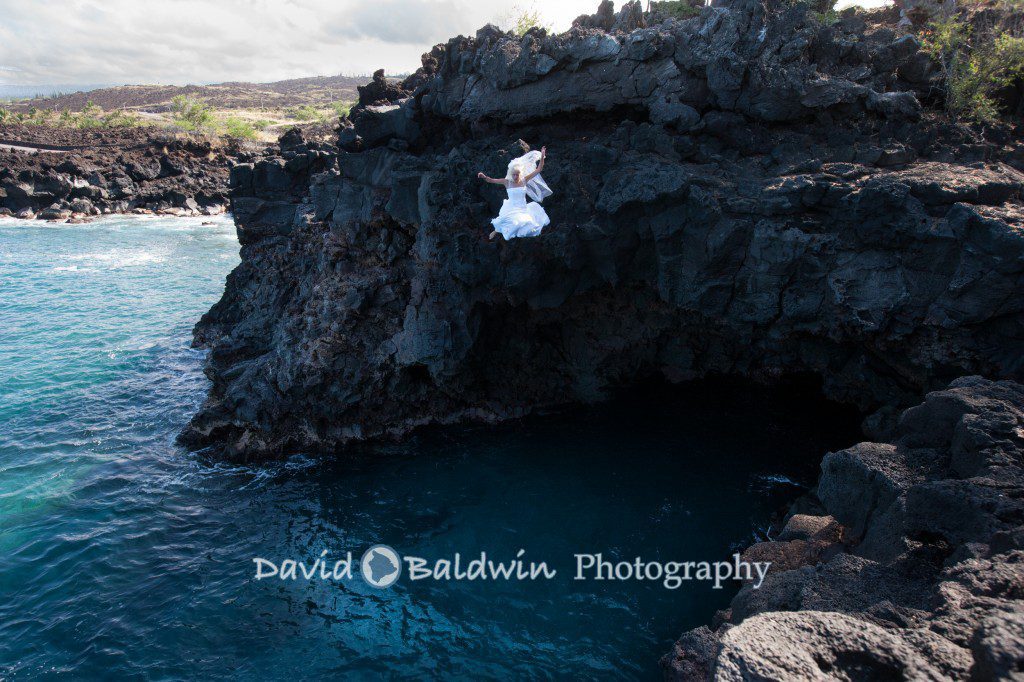 bride trashing the dress by jumping from a cliff