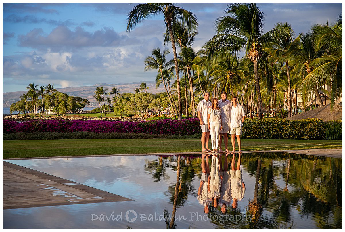 reflection of family in the pool of a private home on the big island
